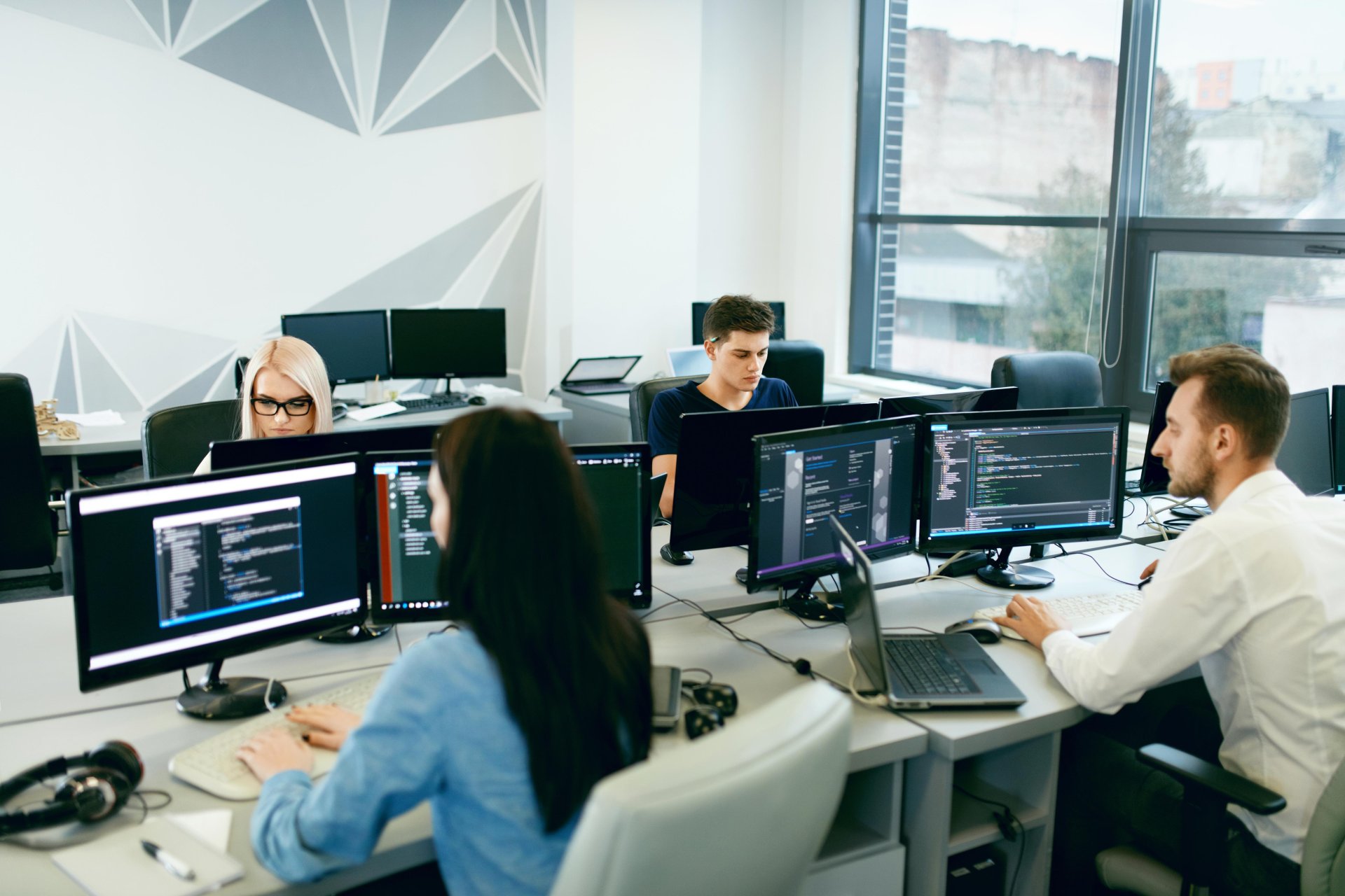 Professional IT experts working on modern software development, web development, AI, and cybersecurity technologies.